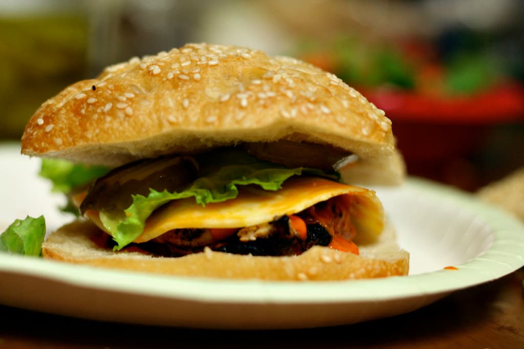 Toasted sesame bagel filled with grilled chipotle chicken, cheese and salad